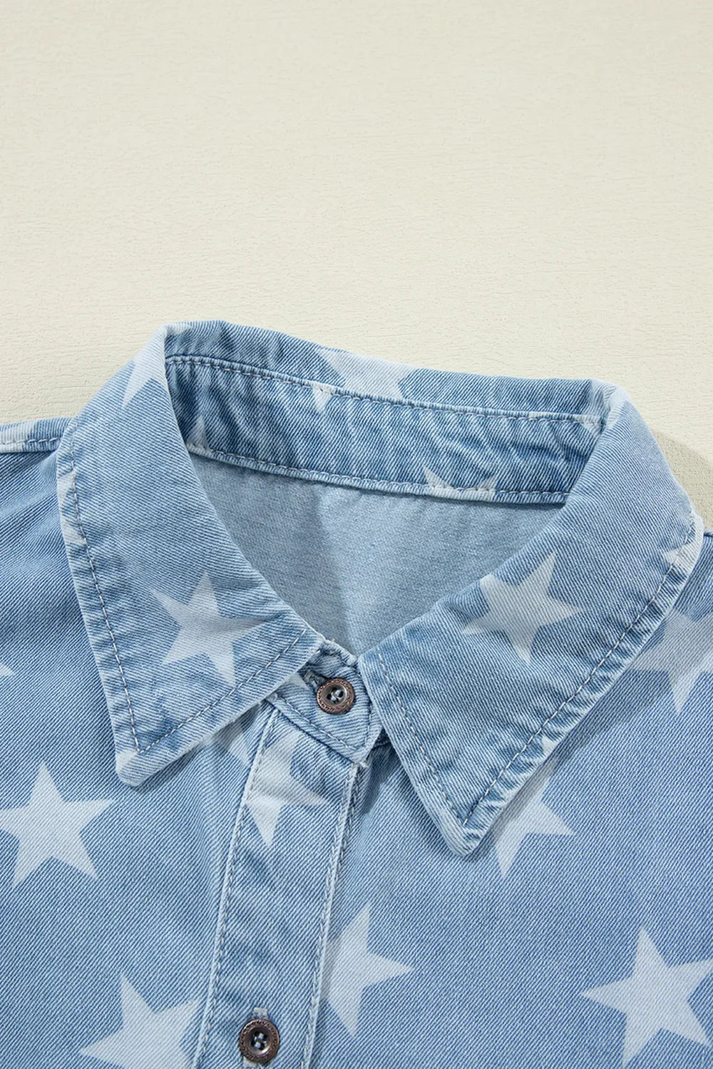 Denim top with a raw hem and star collar, made from a cotton blend.