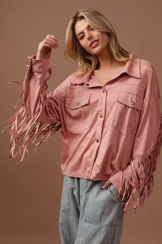 Woman modeling a pink suede fringe long sleeve jacket with button front.