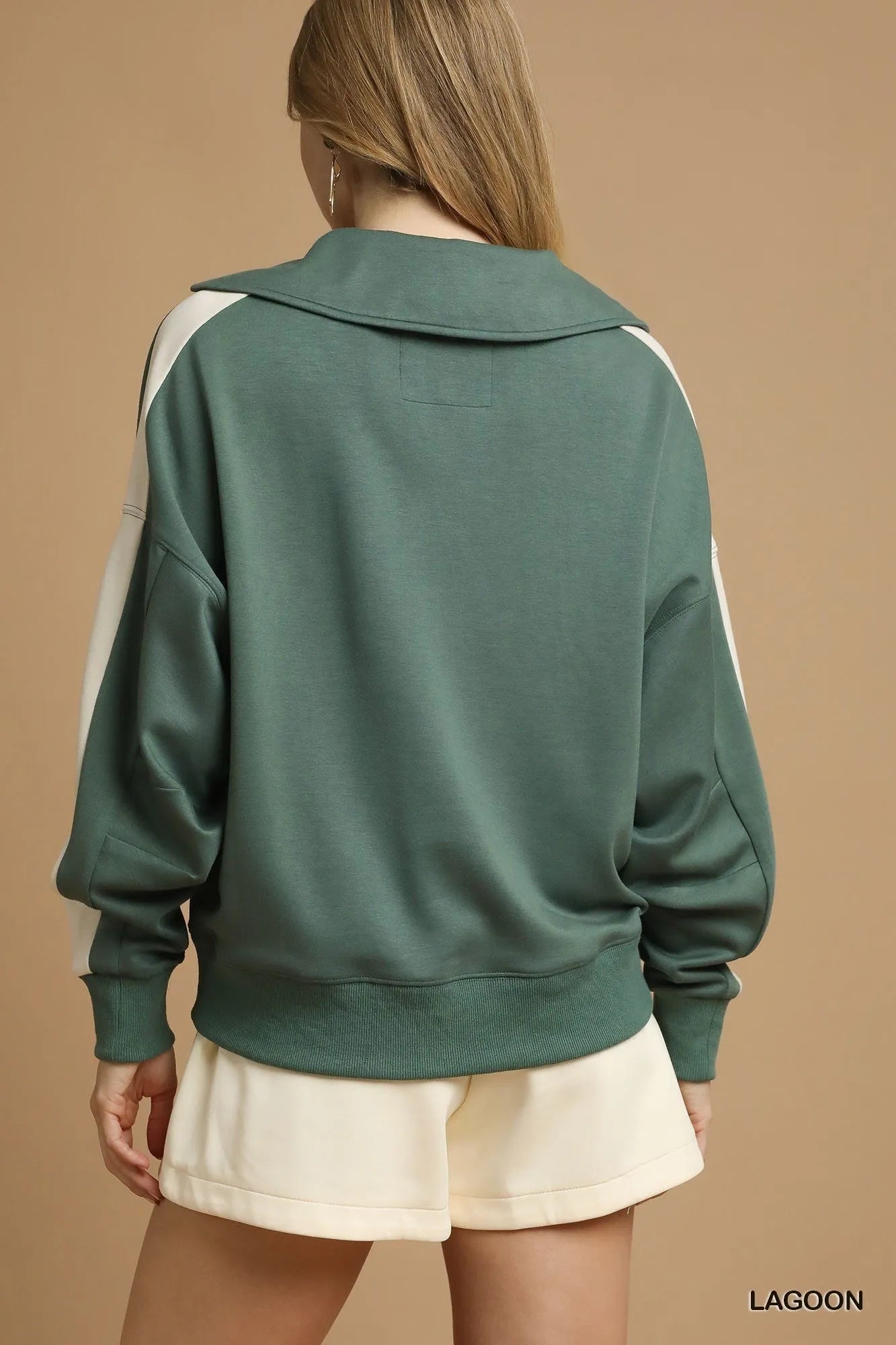 Rear view of sage green contrast long sleeve sweatshirt with white sleeve stripes.