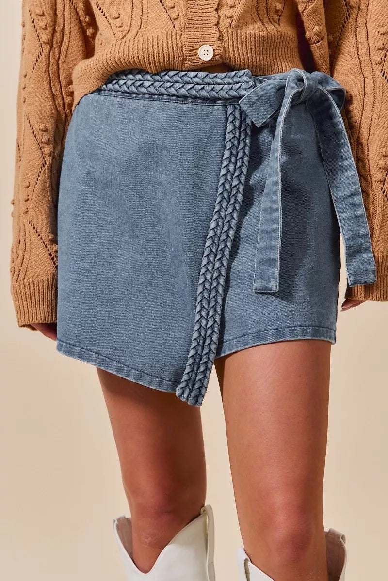 Wrap braided trim denim skort with asymmetrical tie belt and slight stretch.
