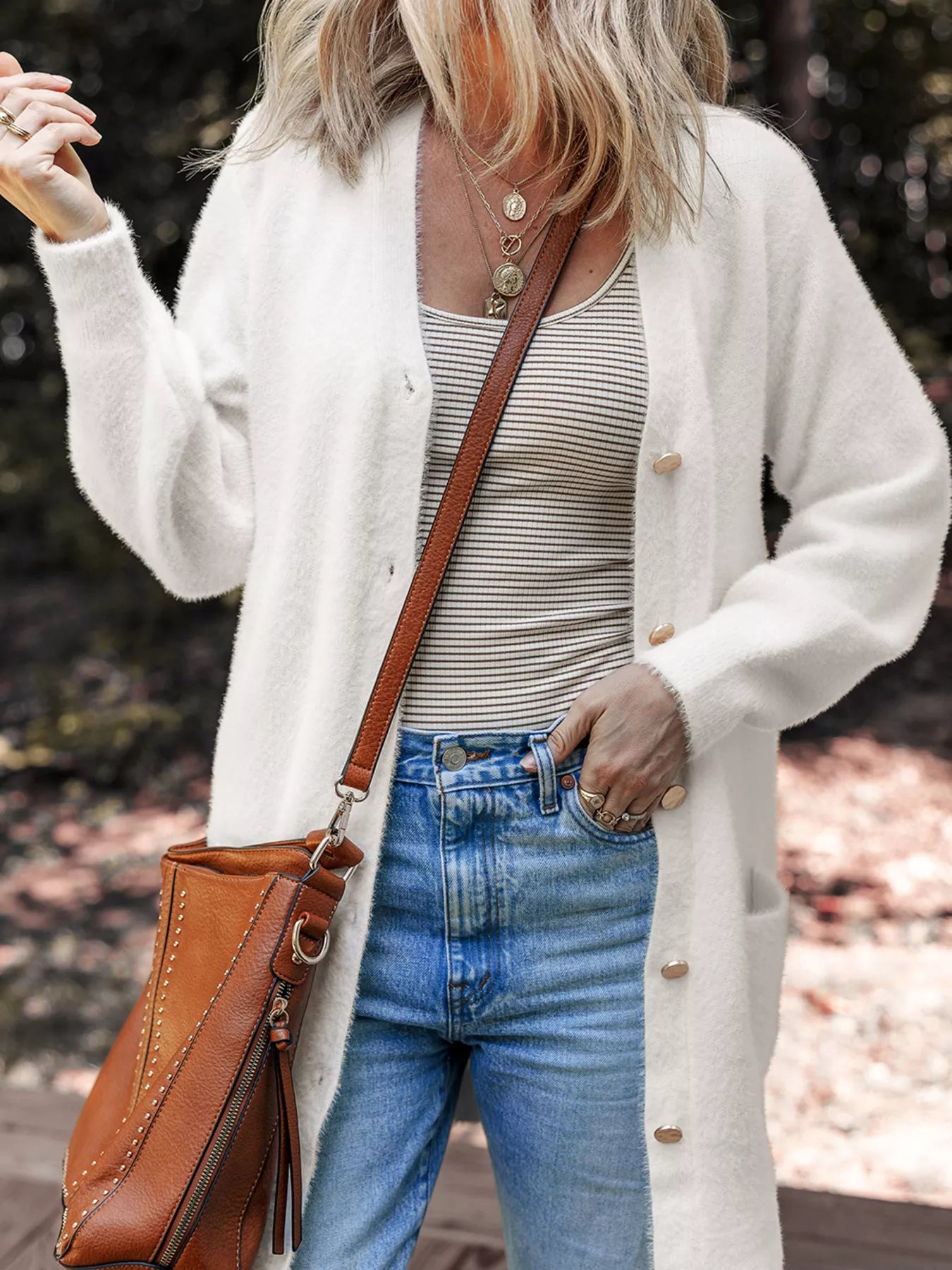 Fuzzy buttoned cardigan in a viscose blend with pockets and a soft, textured surface.