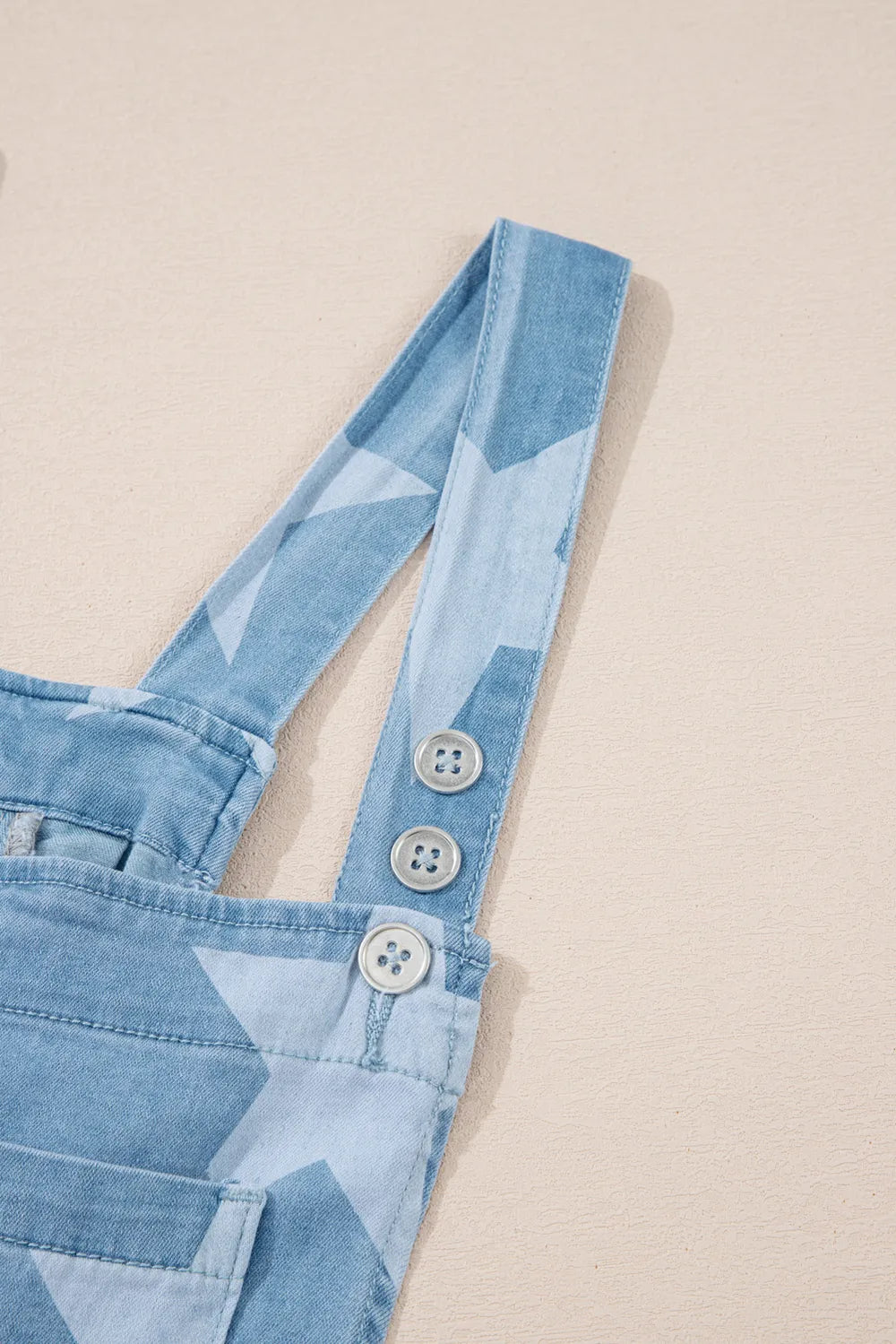 Denim overalls with a star print, square neck, and pockets made from a cotton blend.