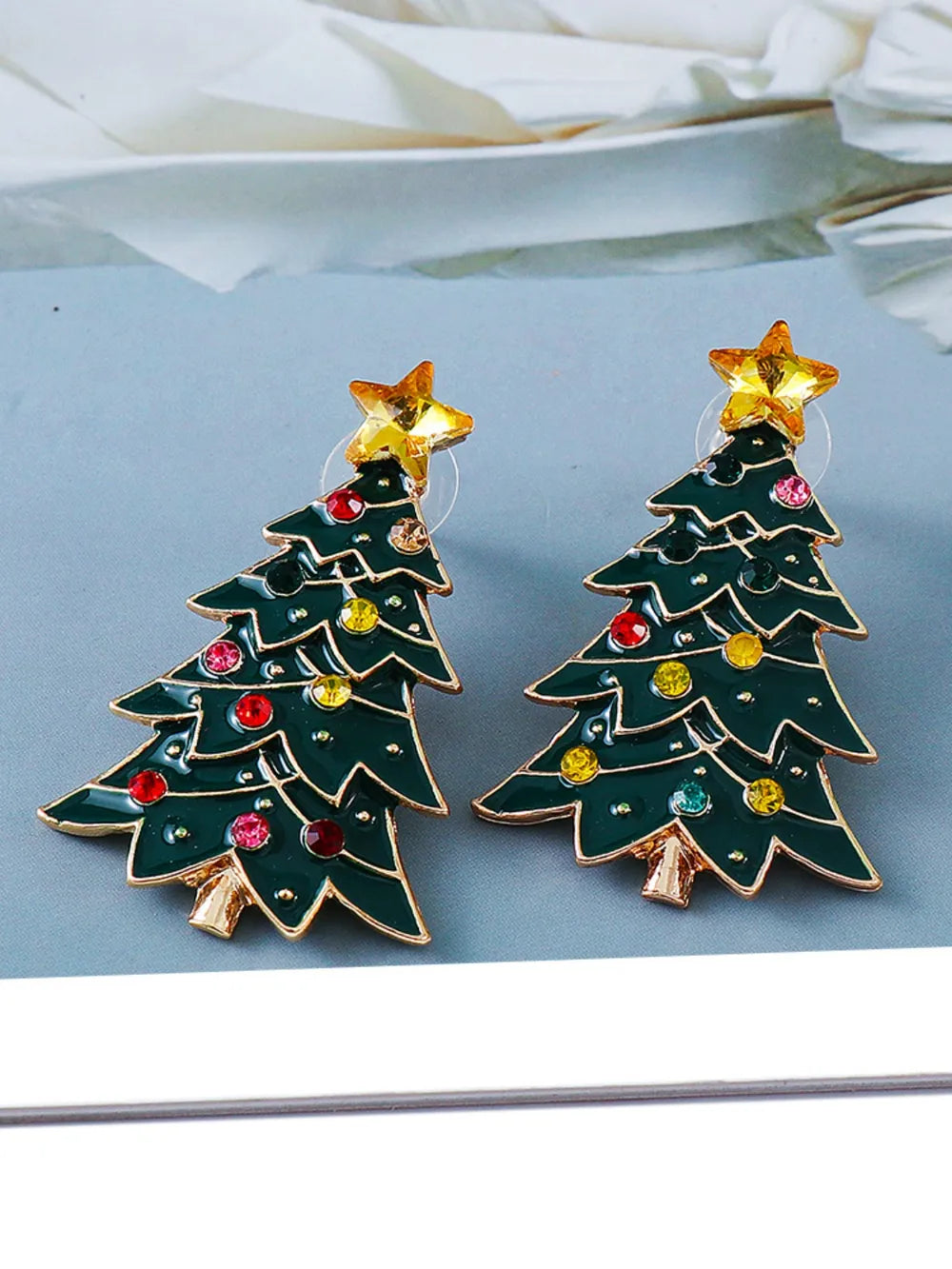 Pair of green alloy Christmas tree earrings inlaid with colorful rhinestones.