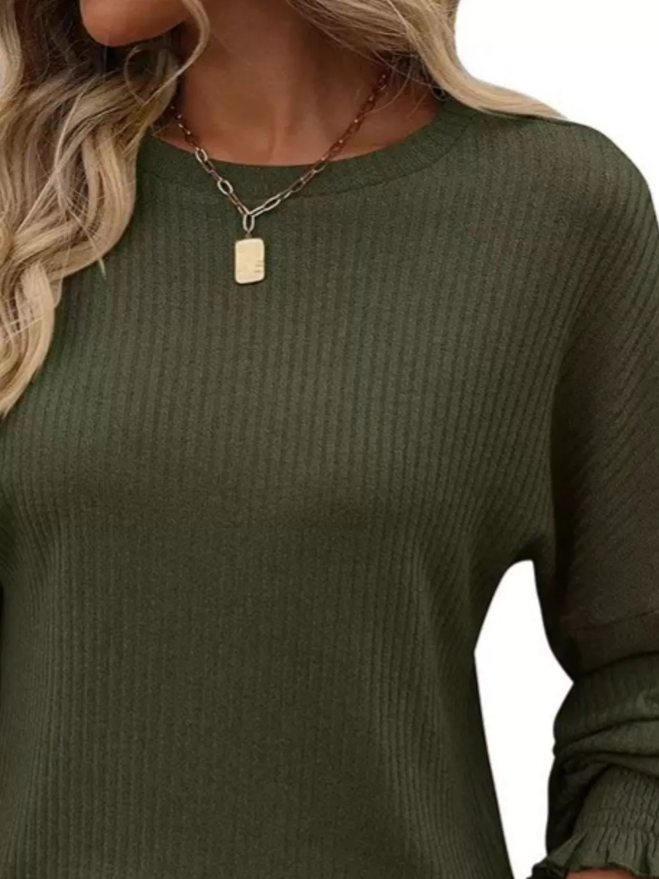 Ribbed long sleeve t-shirt made of stretchy polyester blend in various sizes.