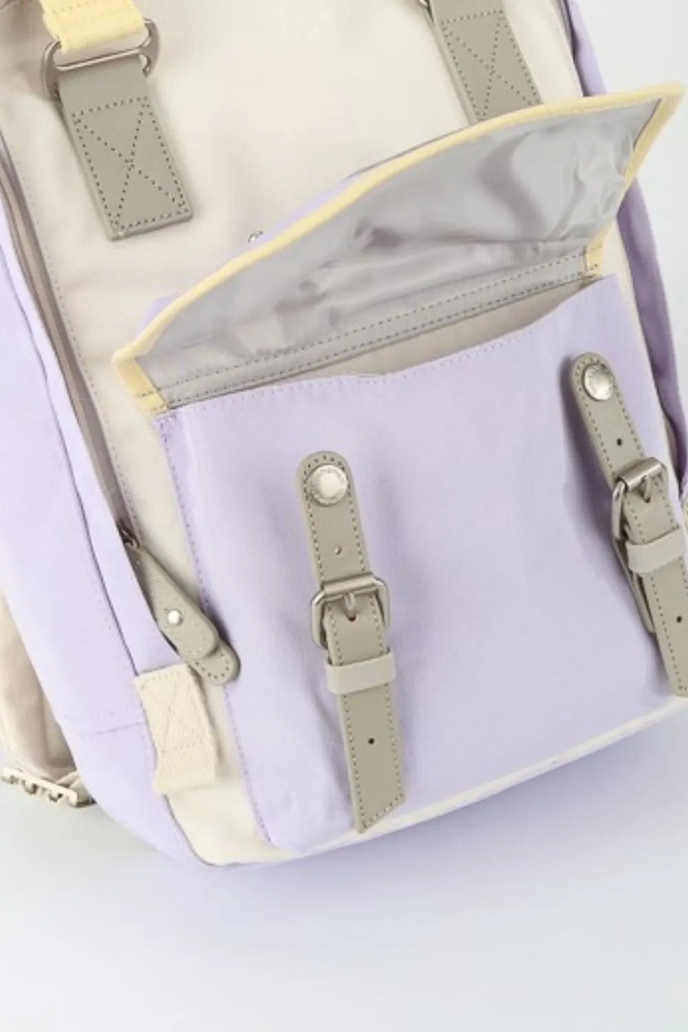Cream and purple water-resistant nylon backpack with contrast straps and pockets.