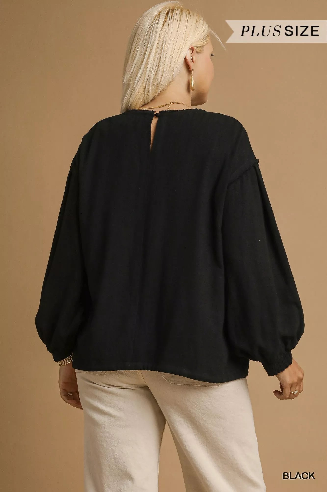 Plus size black linen long sleeve drawstring top, back view on model.