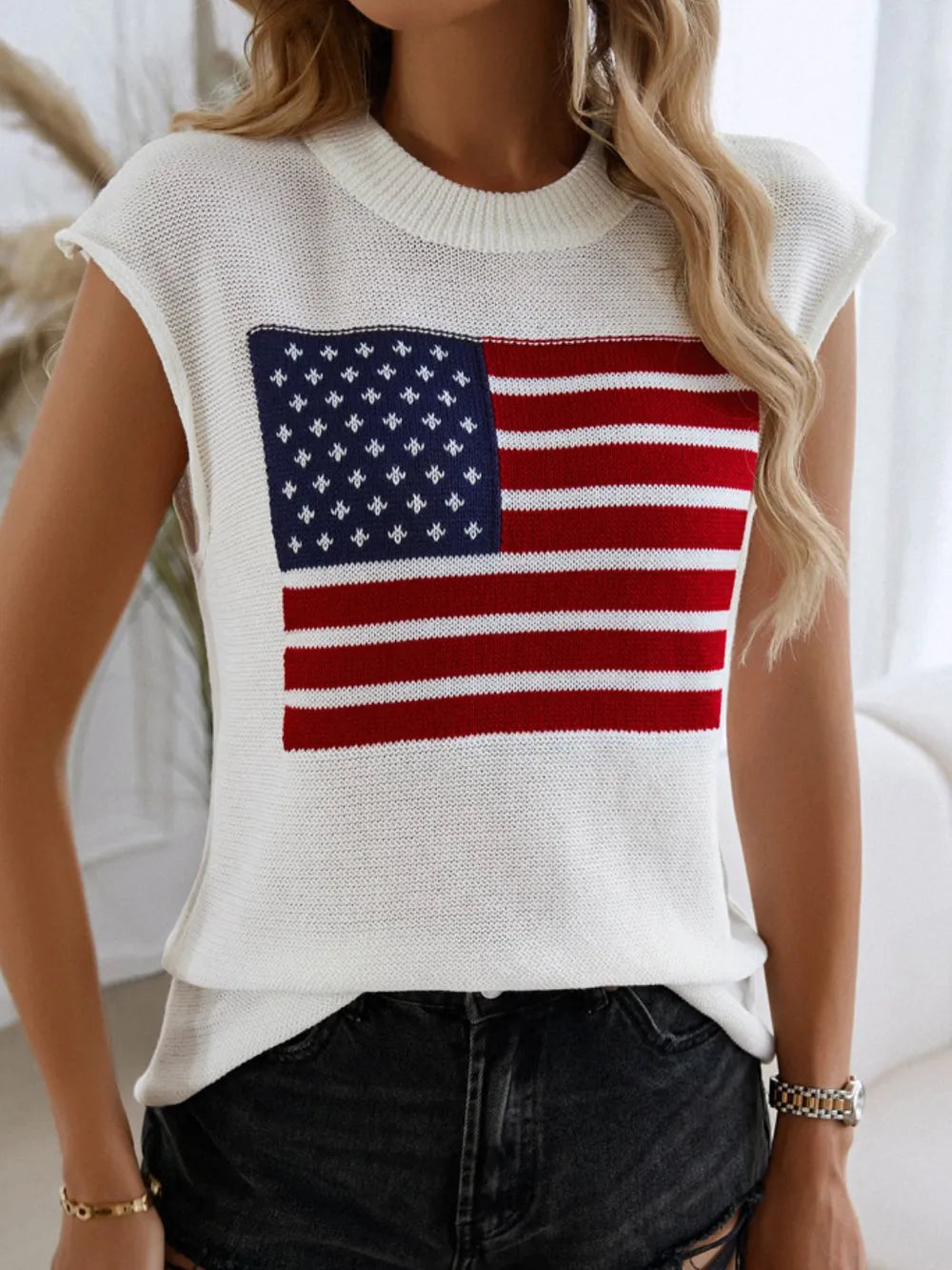 Red, white, and blue US flag sweater vest with round neck and moderate stretch.