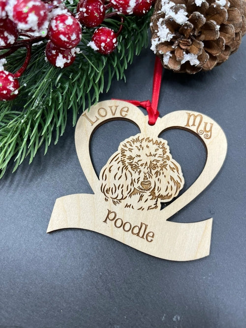 Baltic birch wooden ornament shaped like a poodle with laser-engraved details and ribbon.