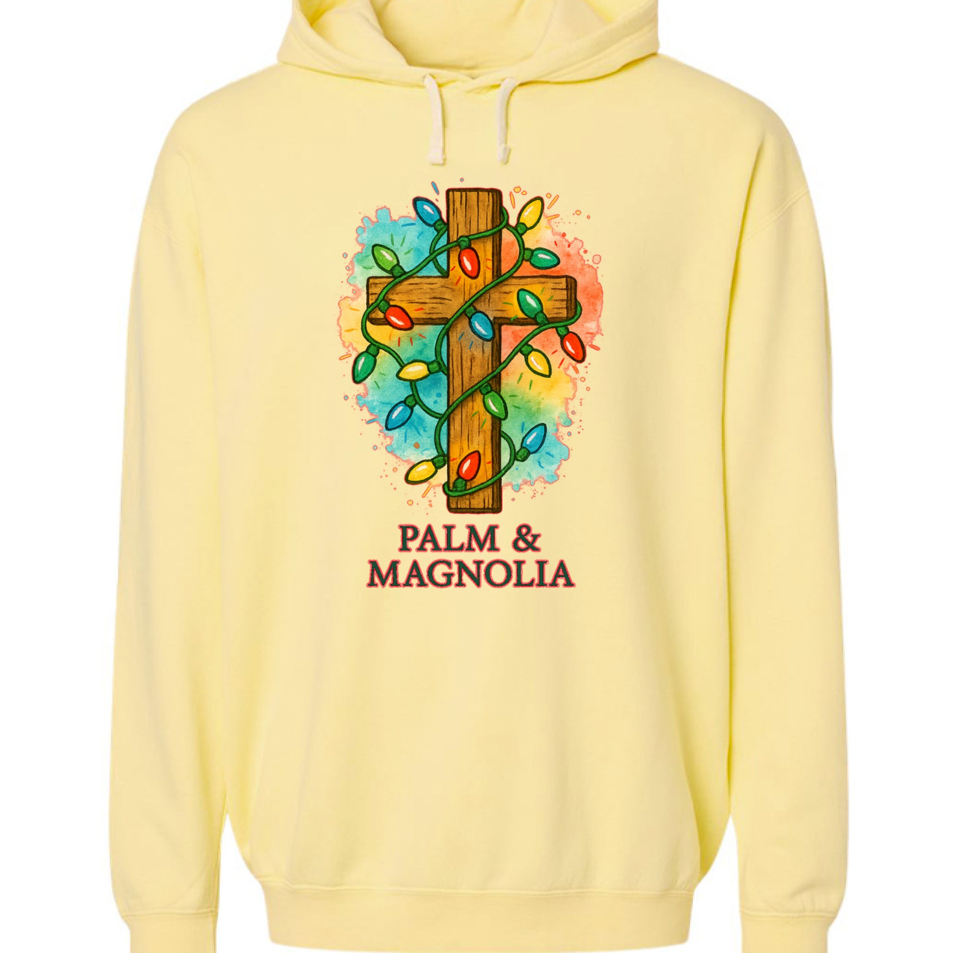 Yellow hoodie with rustic wooden cross wrapped in colorful Christmas lights and "Palm & Magnolia" text.