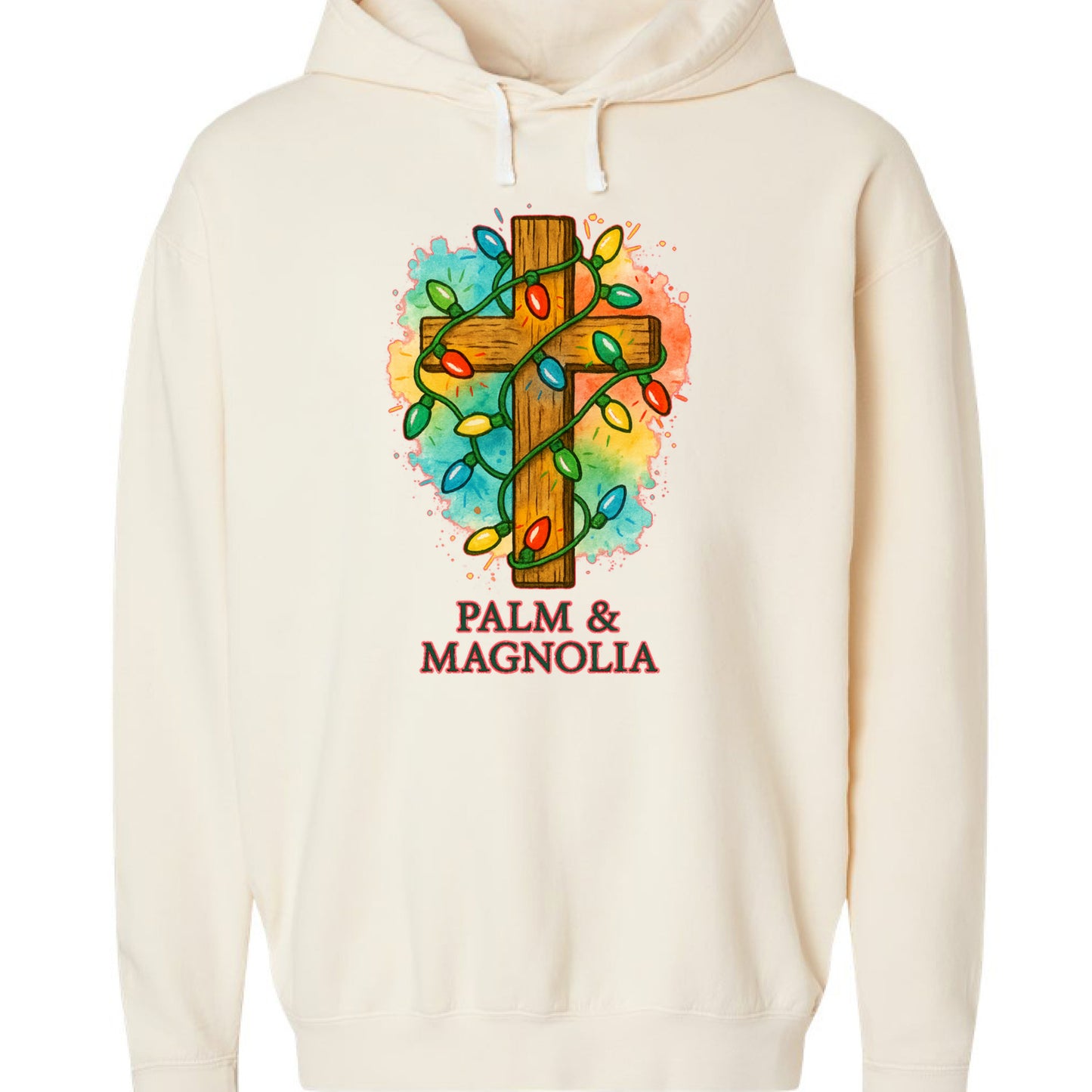 Cream hoodie with rustic wooden cross wrapped in colorful Christmas lights and Palm & Magnolia text.