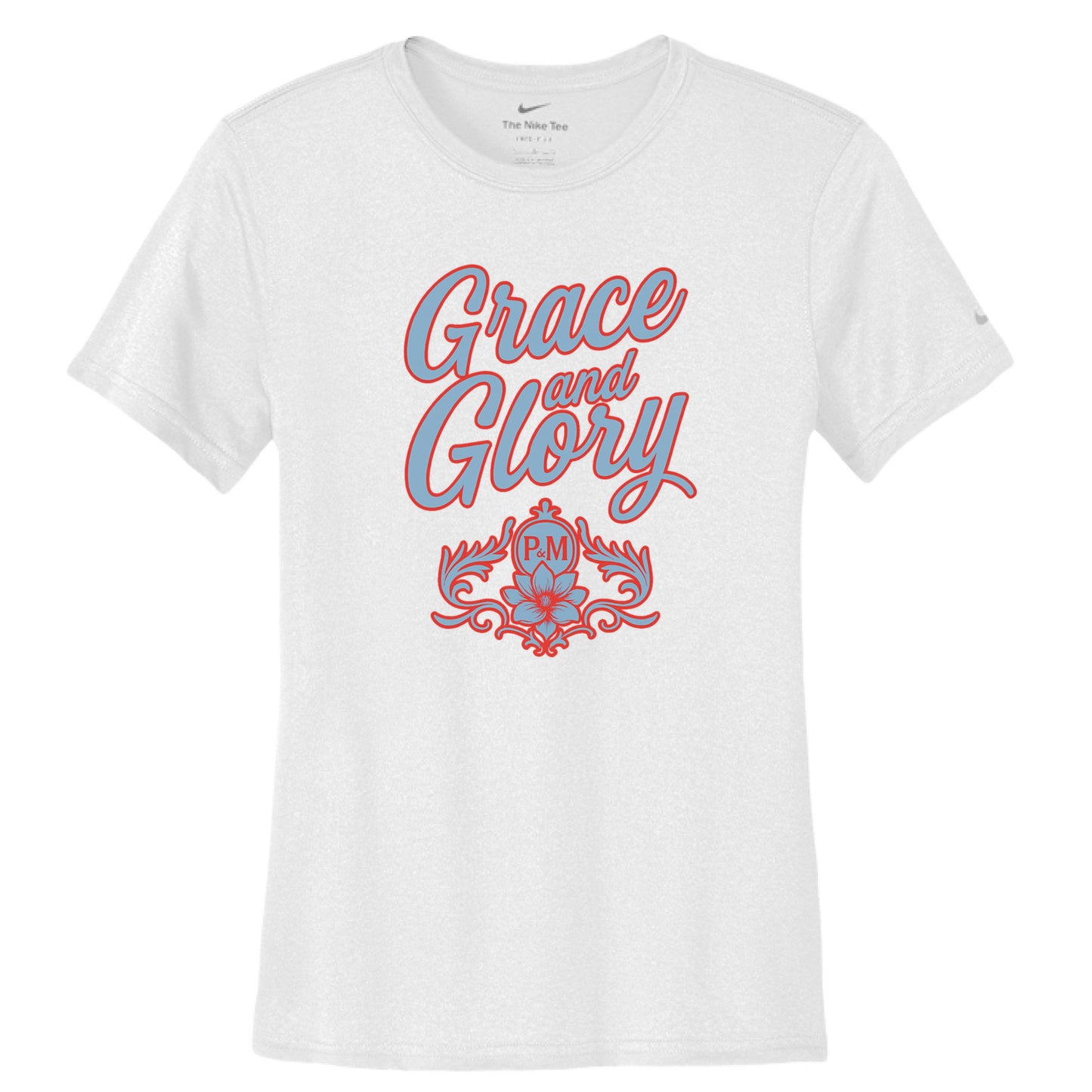 White Nike women's Dri-FIT tee with "Grace & Glory" text and floral emblem in powder blue.