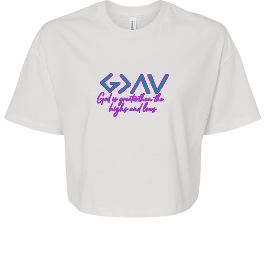 White crop tee with "God is Greater" graphic, oversized sleeves, and relaxed fit.