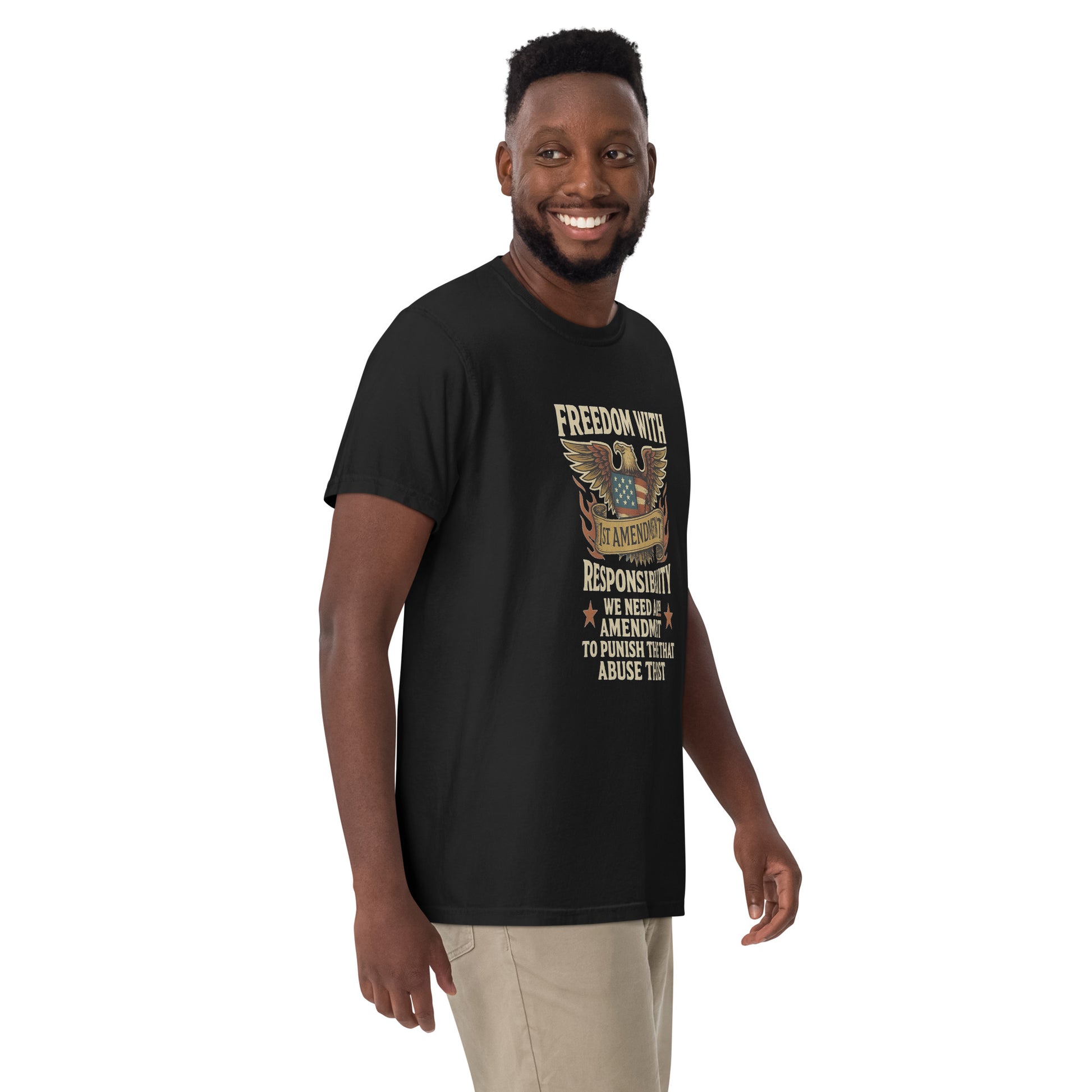 A smiling Black man models a black unisex heavyweight t-shirt with a 28th Amendment eagle graphic.