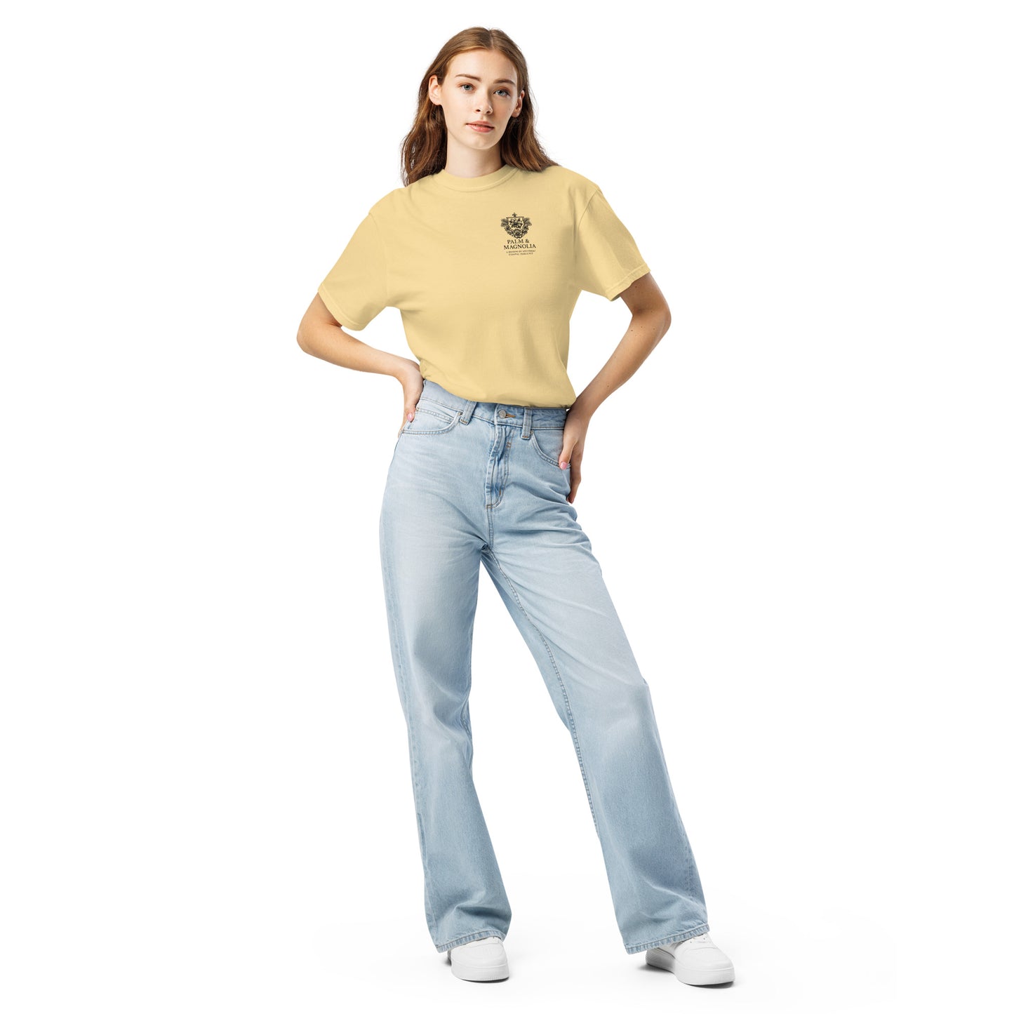 Woman modeling a yellow Comfort Colors tee with Coastal Companions Hard Rock Bronco design, paired with light blue jeans.