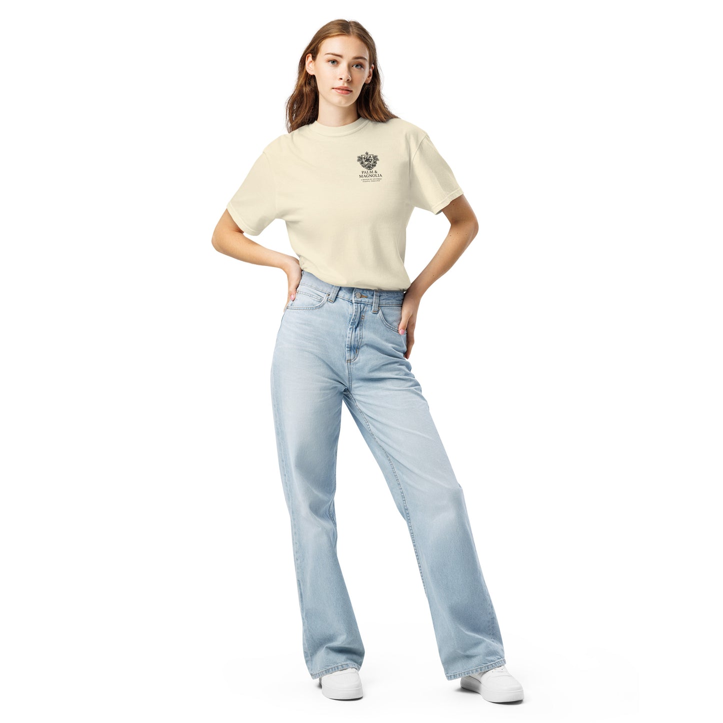 Woman modeling a beige Comfort Colors tee with Hard Rock Bronco print and light blue jeans.