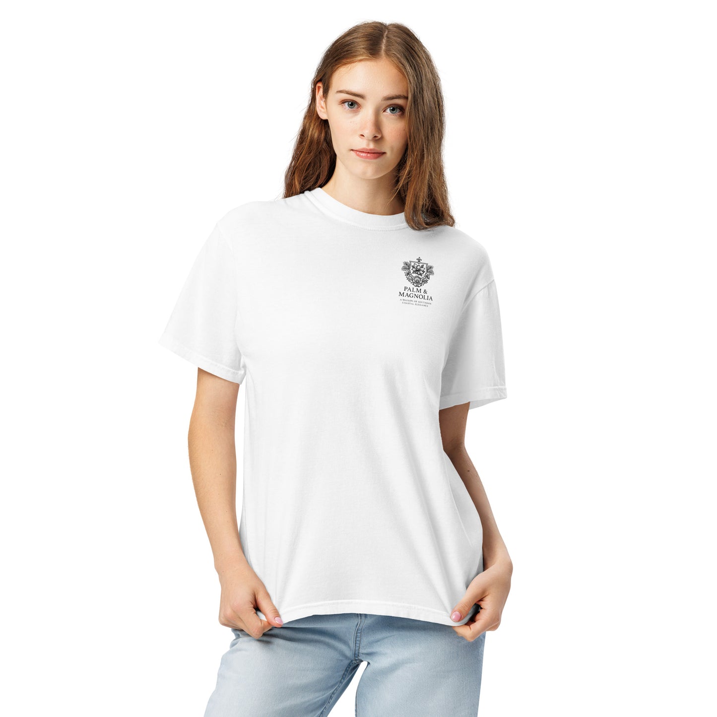 A woman models a white Comfort Colors t-shirt with a subtle embroidered crest on the chest.