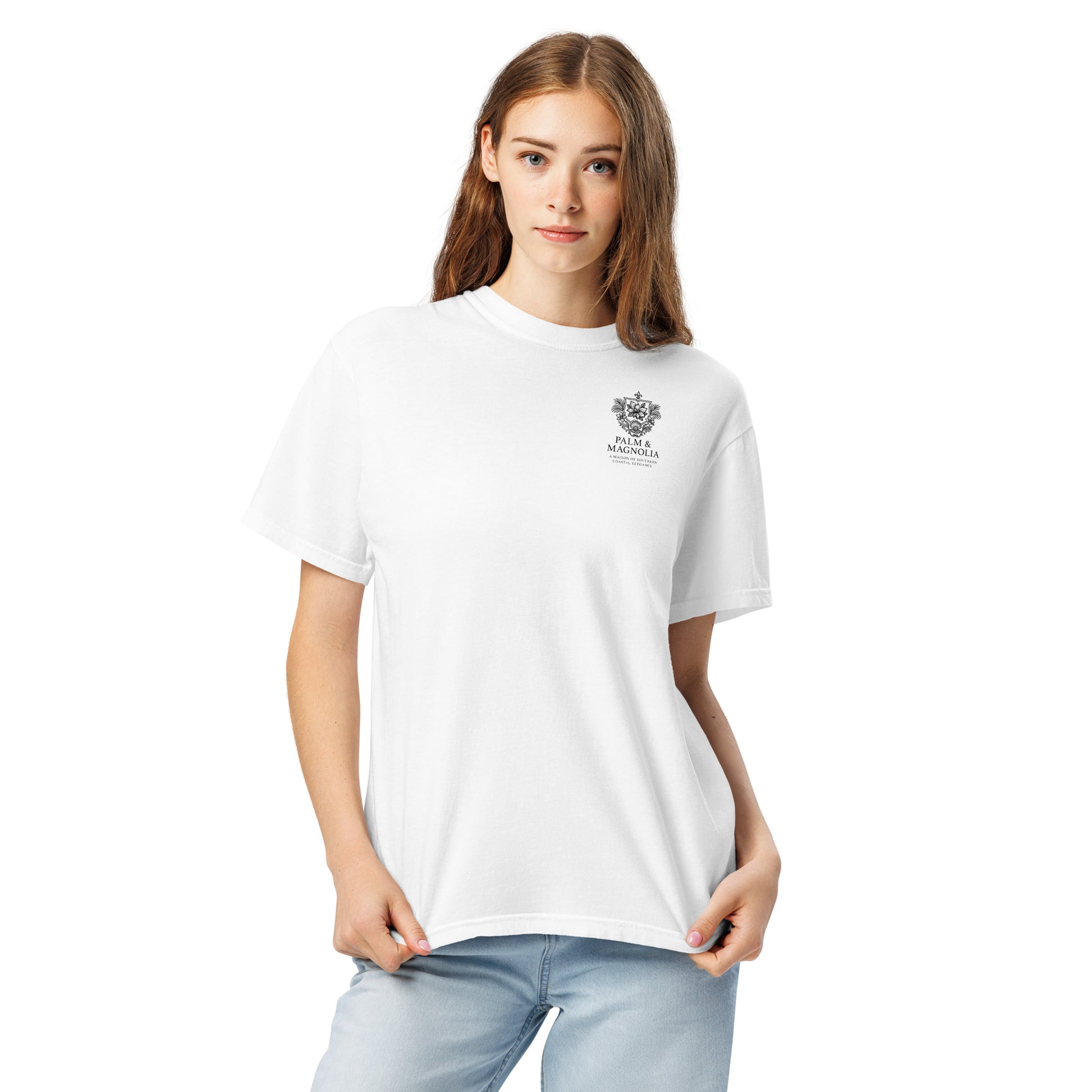 A woman models a white Comfort Colors t-shirt with a subtle embroidered crest on the chest.