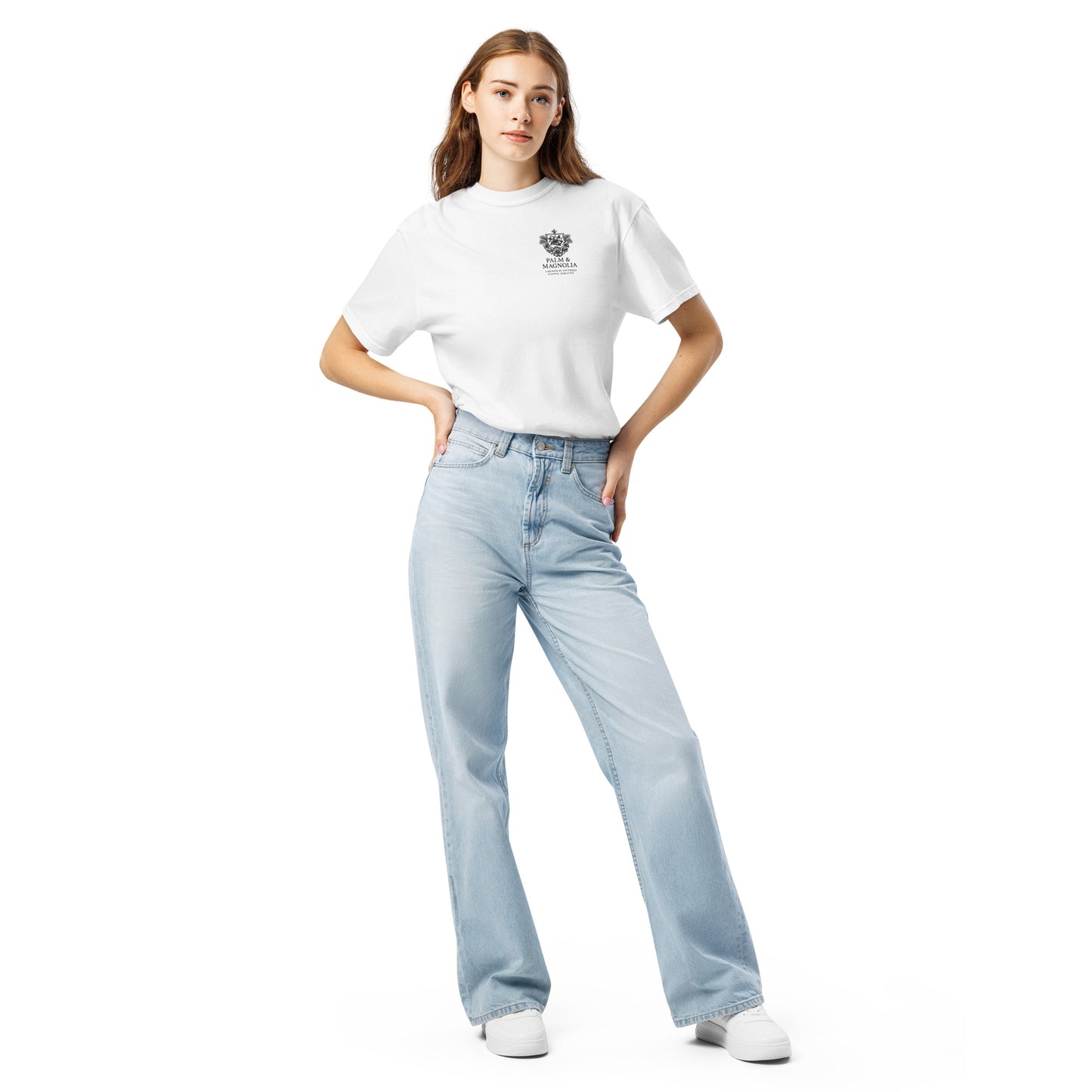 Model poses in white Comfort Colors tee with Coastal Companions Hard Rock Bronco print and light blue jeans.