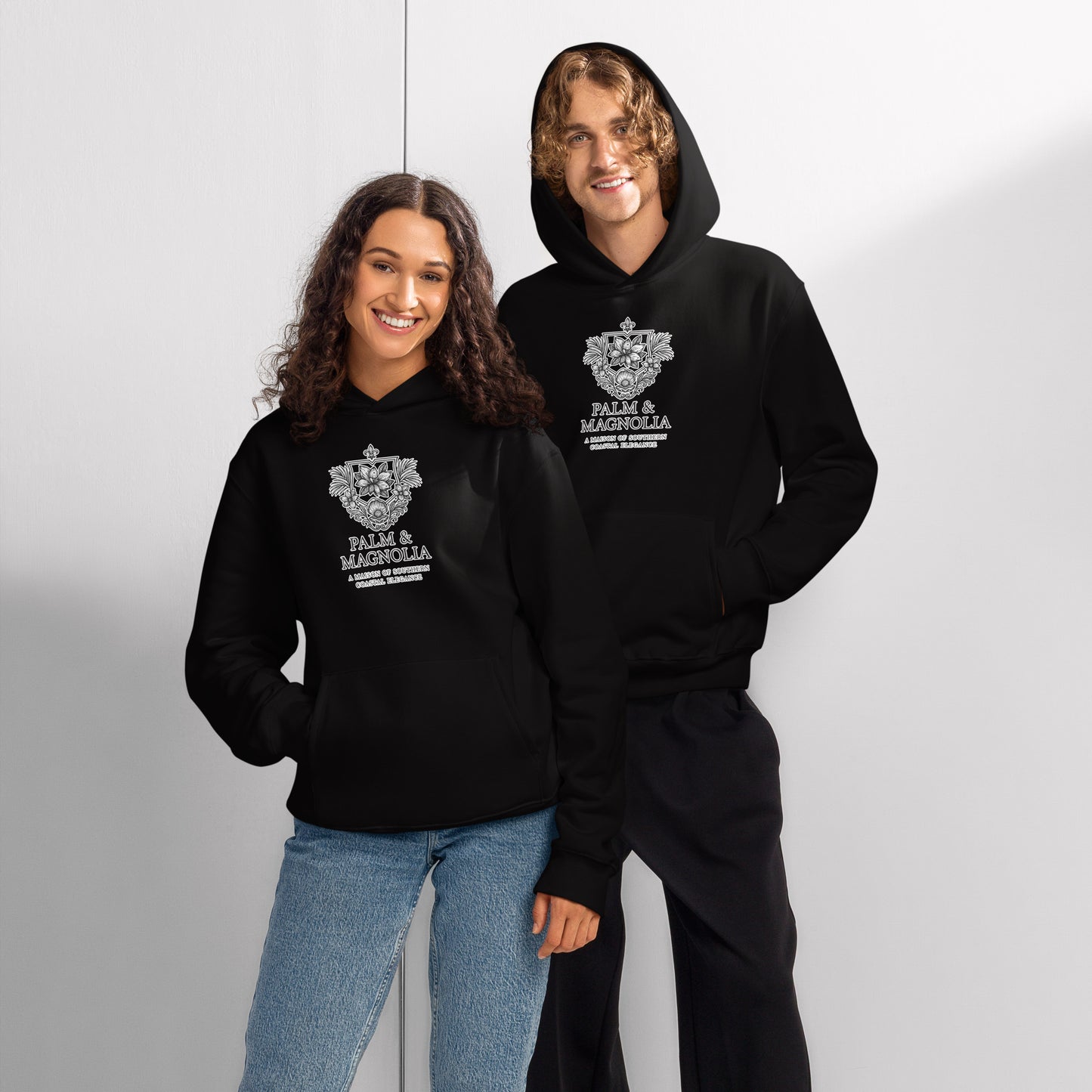 Oversized black hoodie with "Hope Anchors the Soul" print, modeled by a smiling couple.