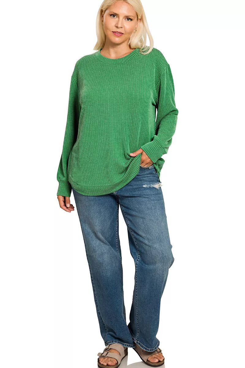 A plus-size woman models a green raised rib round neck long sleeve top.