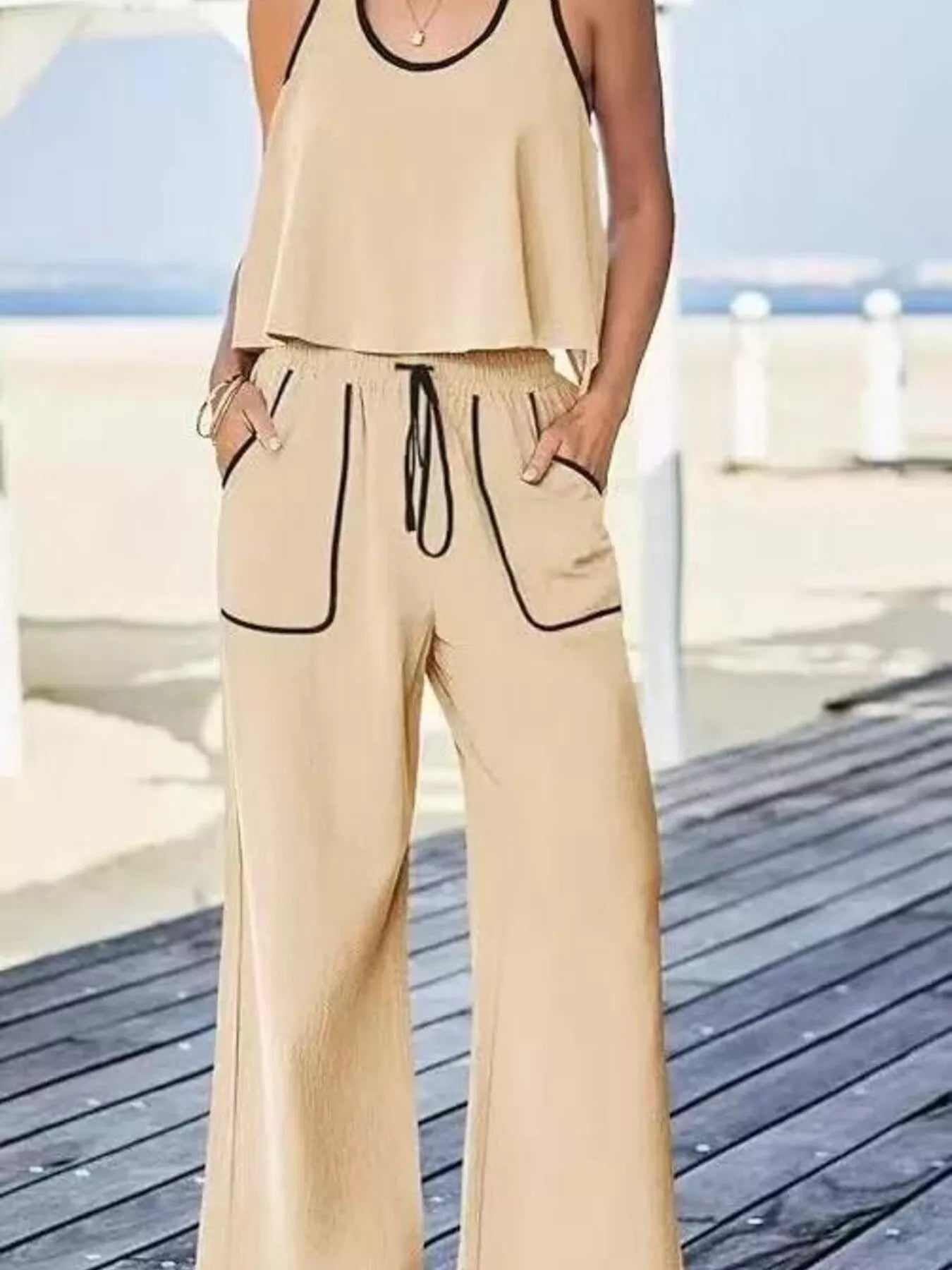 Two-piece tank and pants set with contrast trim and drawstring pockets in polyester spandex.