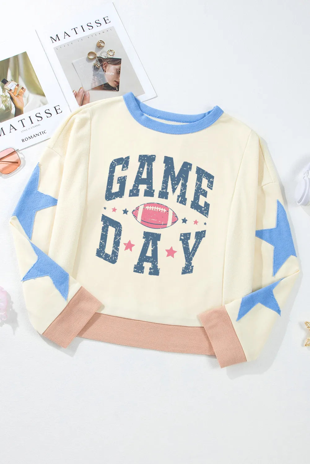 Round neck long sleeve sweatshirt with star patch design in a basic style.
