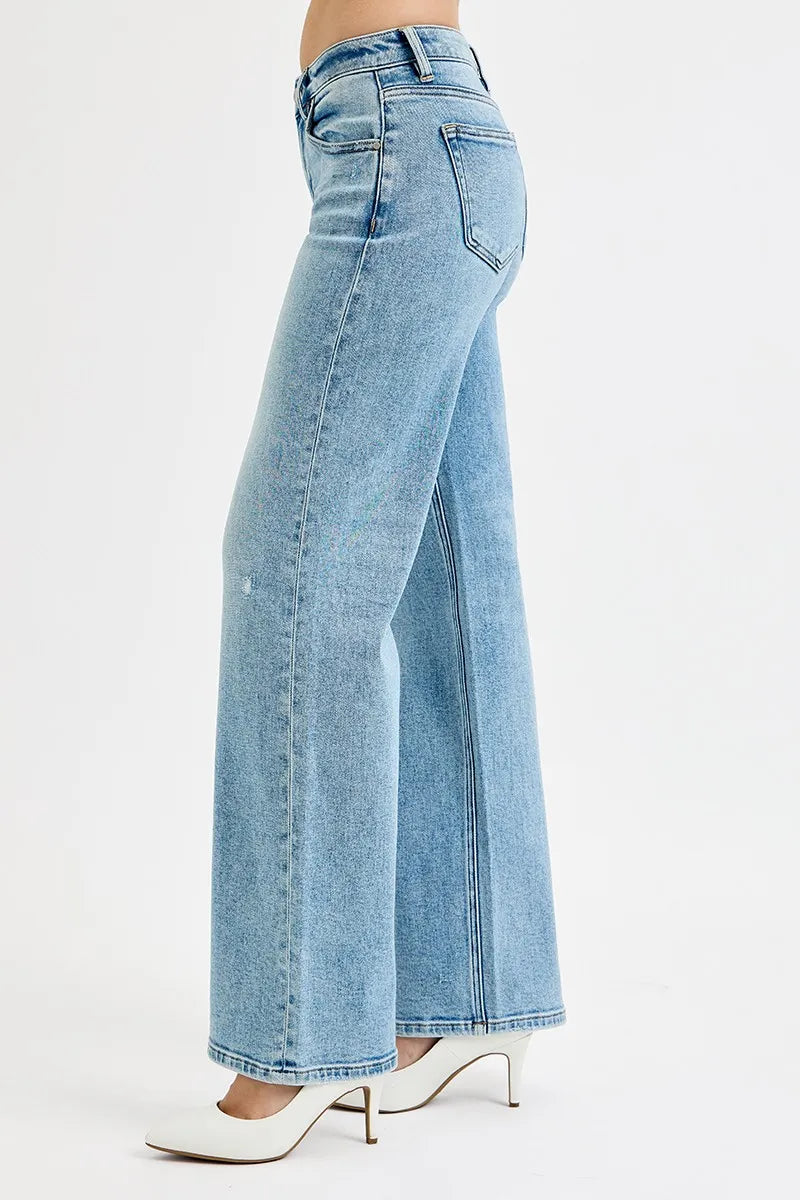 Light wash wide leg flare boyfriend jeans in plus size, side view on model.
