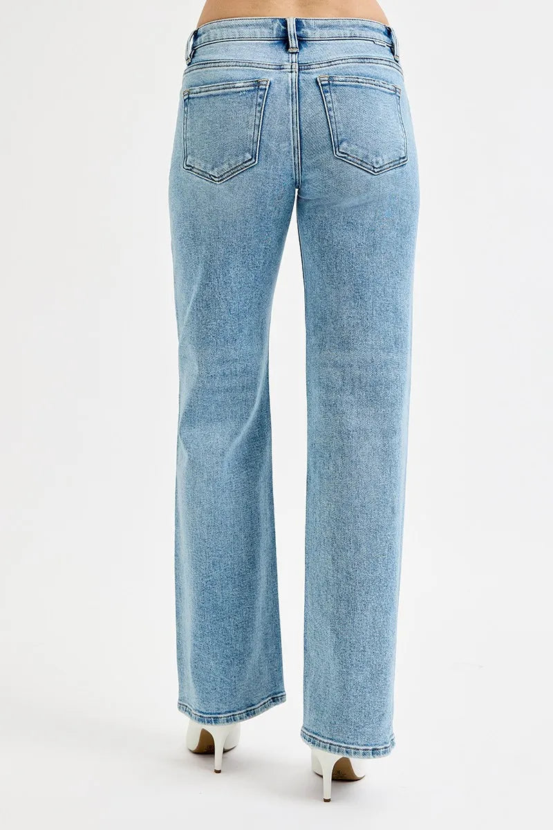 Rear view of light wash wide leg flare boyfriend jeans on a plus-size model.