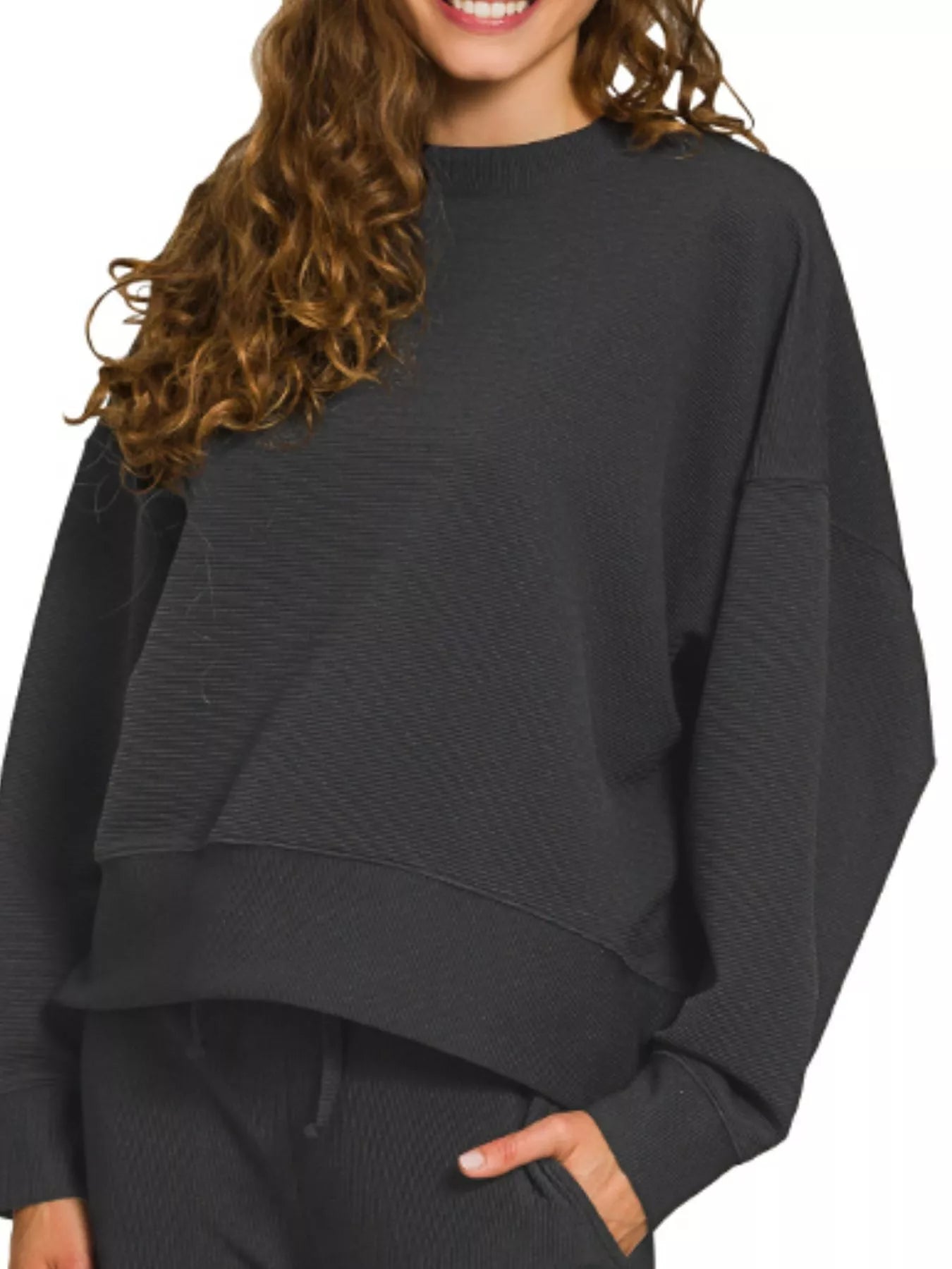 Woman modeling black ribbed round neck pullover and drawstring pants set.