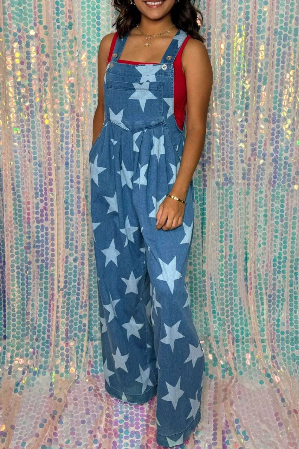 Wide leg denim overalls with star print and pockets, made from a cotton blend.