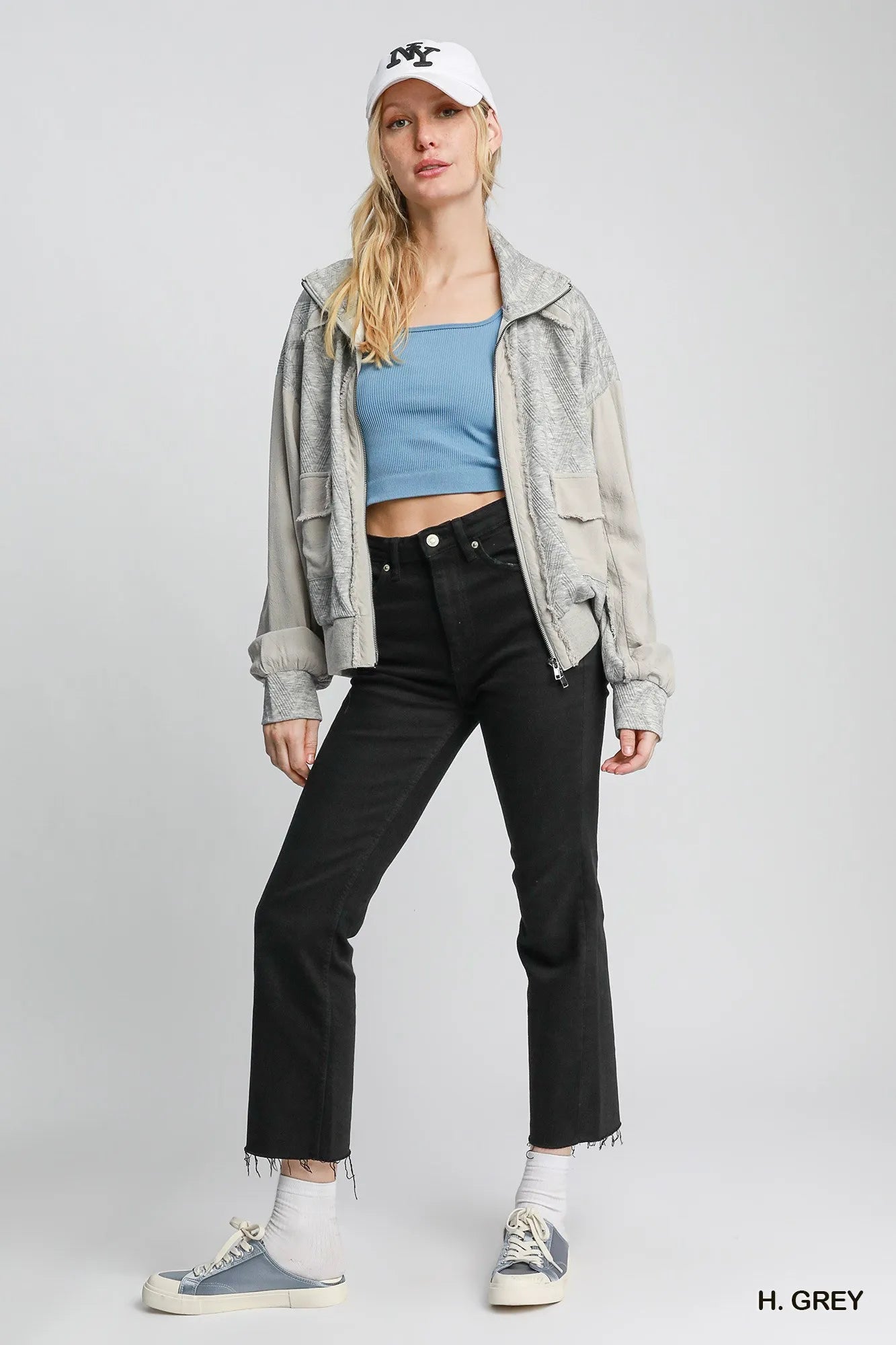 Woman modeling gray two-way jacquard zip-up linen jacket with hood.