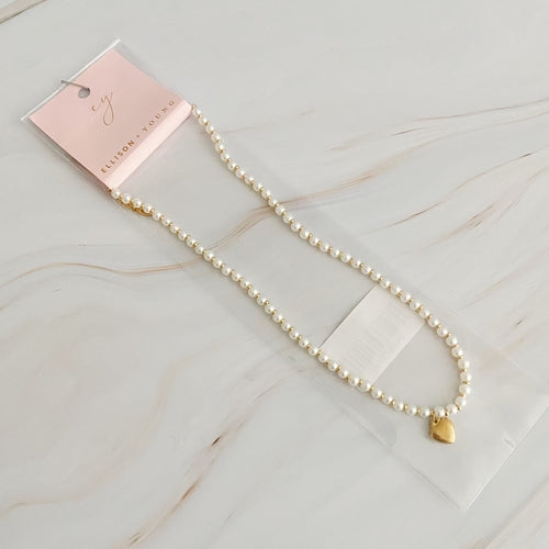 Pearl and gold bauble heart necklace with alternating beads and heart charm.