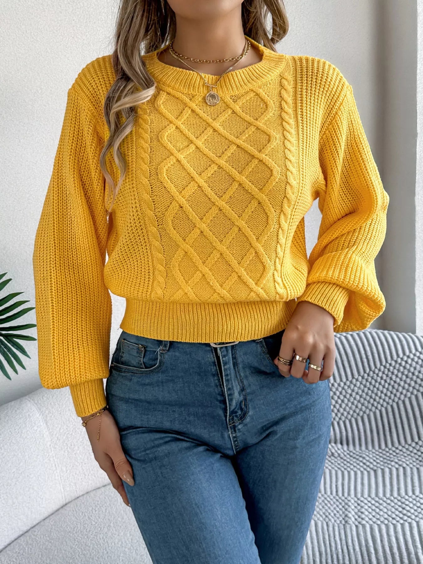 Long sleeve acrylic sweater featuring a cable knit diamond pattern in a cozy fit.