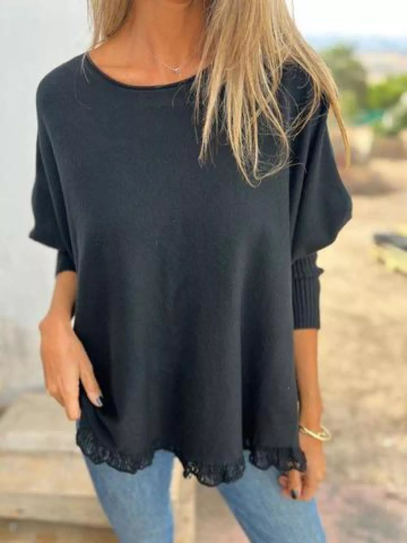 Plus size round neck long sleeve knit top in soft fabric with lace trim detail.