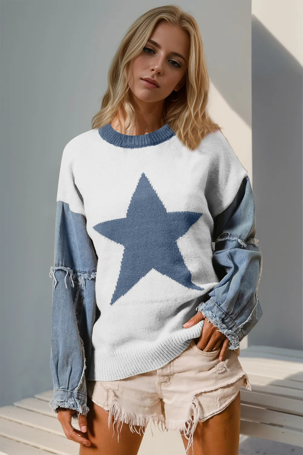 Long sleeve sweater with a raw edge and star pattern in a cotton blend fabric.