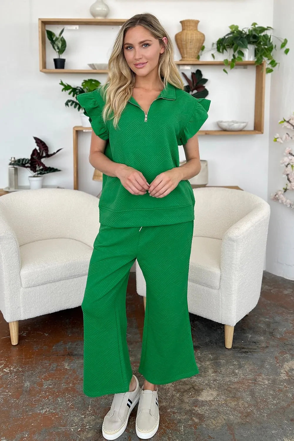 Woman modeling green textured ruffle short sleeve top and wide leg pants set.