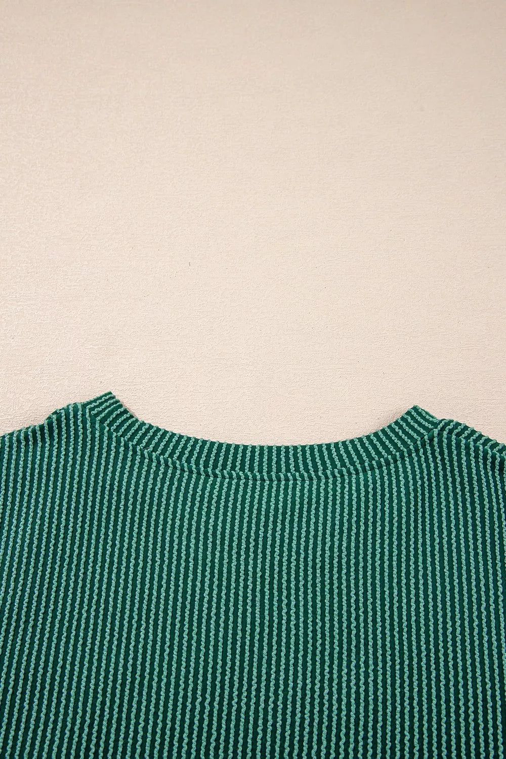Back view of green ribbed polyester top with crew neck in two-piece set.