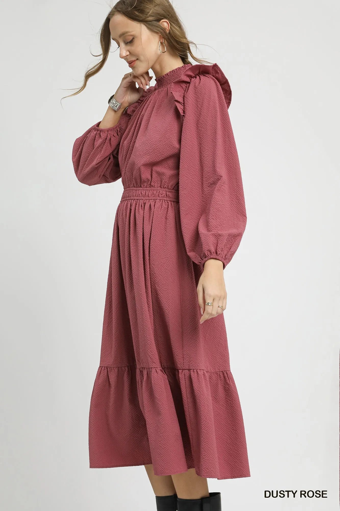 Dusty rose textured midi dress with ruffle shoulders and puffed sleeves.