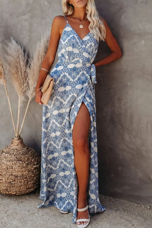 Blue ikat printed tied maxi cami dress on a model, with spaghetti straps, wrap front, and side slit.