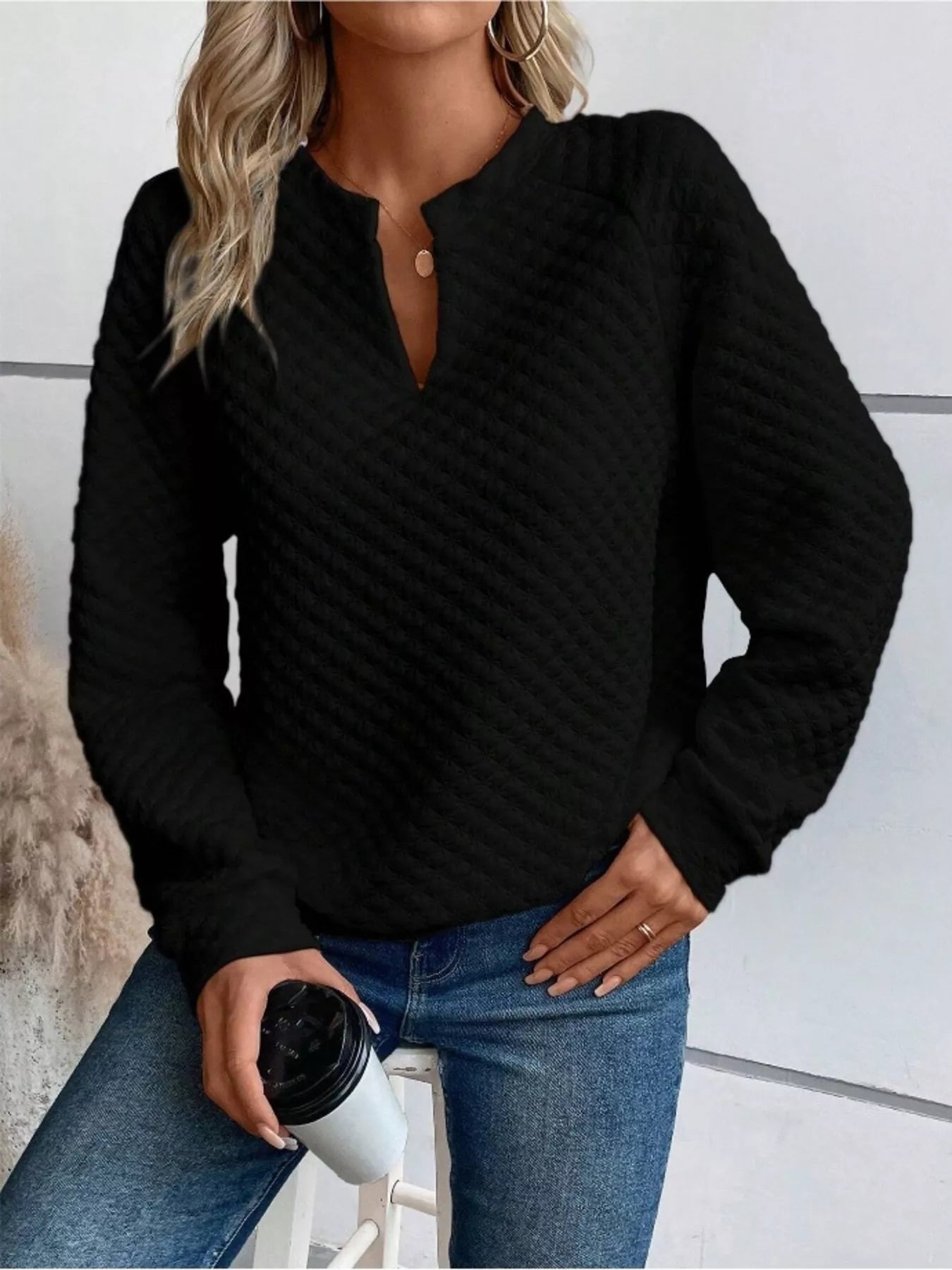 Gray textured sweatshirt with notched raglan sleeves and a relaxed fit.