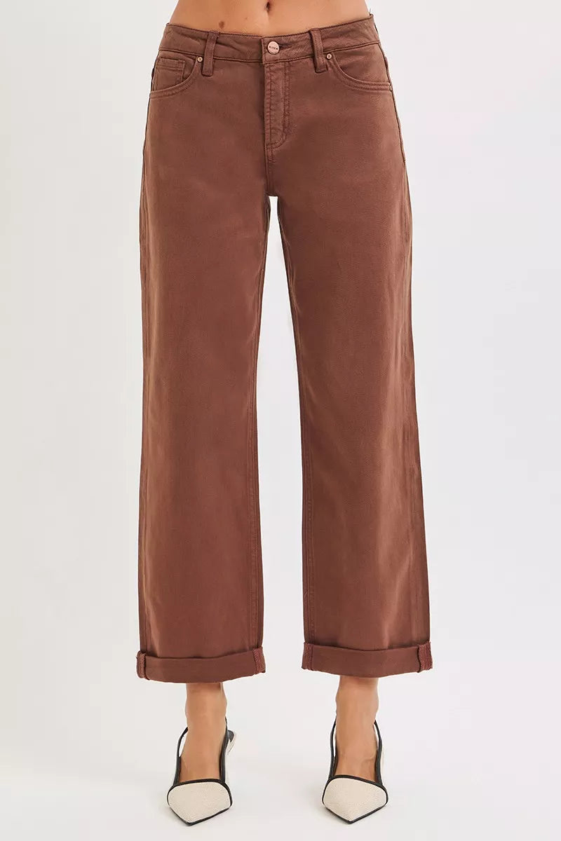 Brown wide-leg high-rise jeans with cuffed hems, modeled on a plus-size figure.