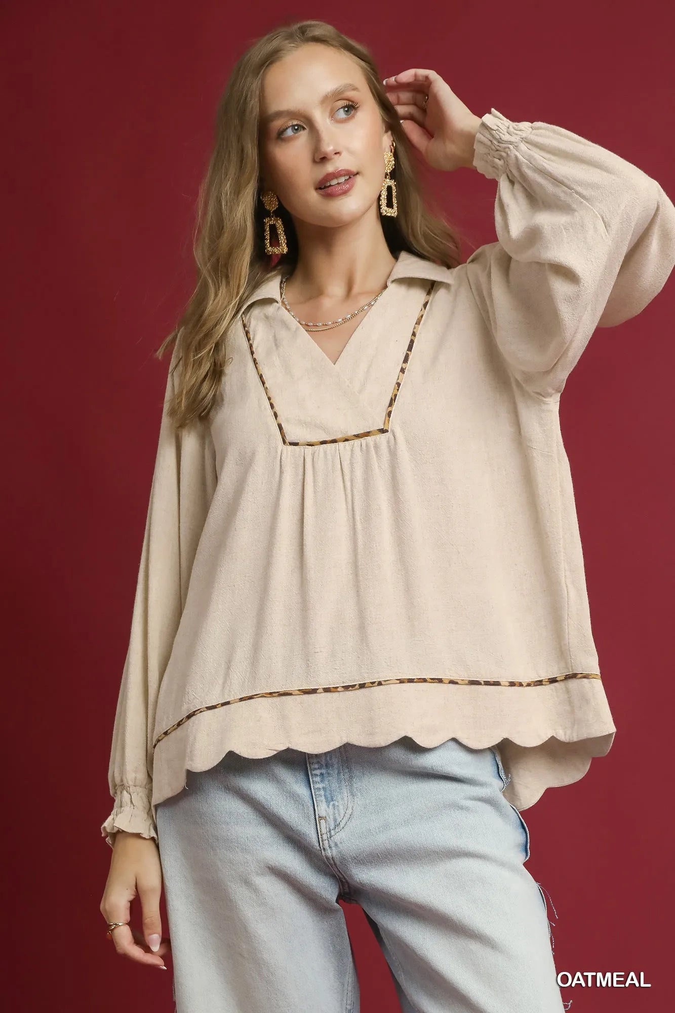 Woman modeling beige linen scallop hem blouse with contrast trim.