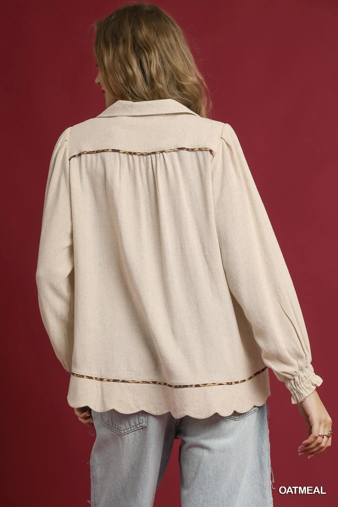 Rear view of women's linen scallop hem blouse with contrast trim, in beige.