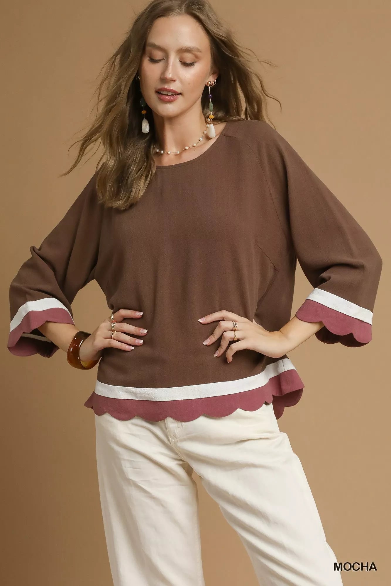Woman modeling brown and white scalloped hem color block linen blend top with 3/4 sleeves.