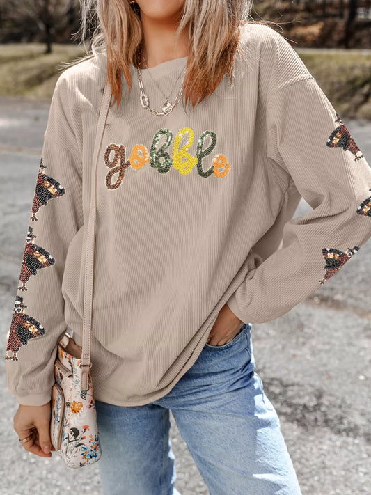 Gobble corded ribbed turkey sequin sweatshirt in taupe with butterfly sleeves.