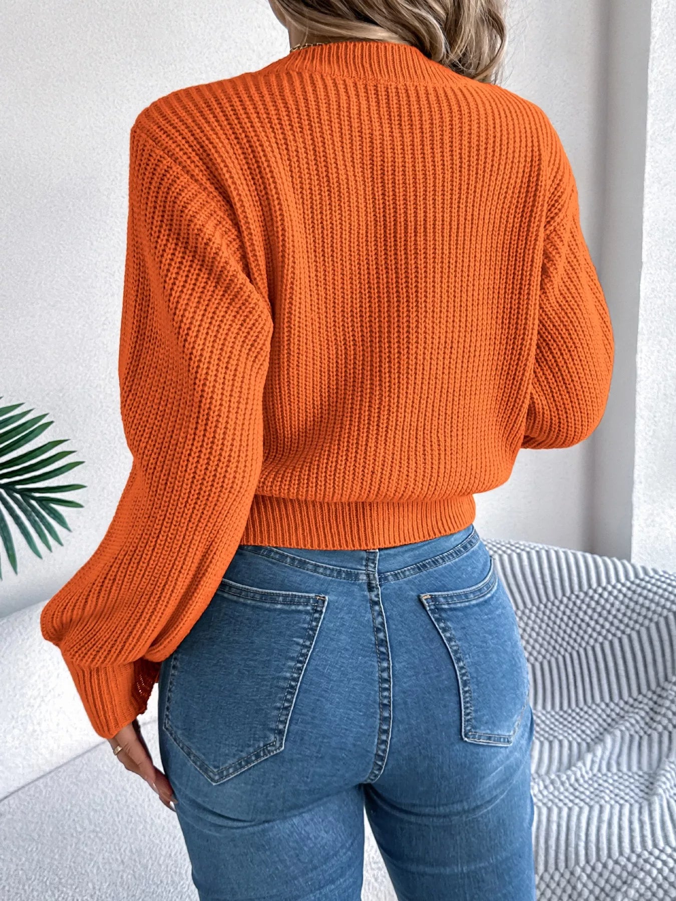 Acrylic sweater featuring a cable knit diamond pattern and long sleeves in a cozy fit.