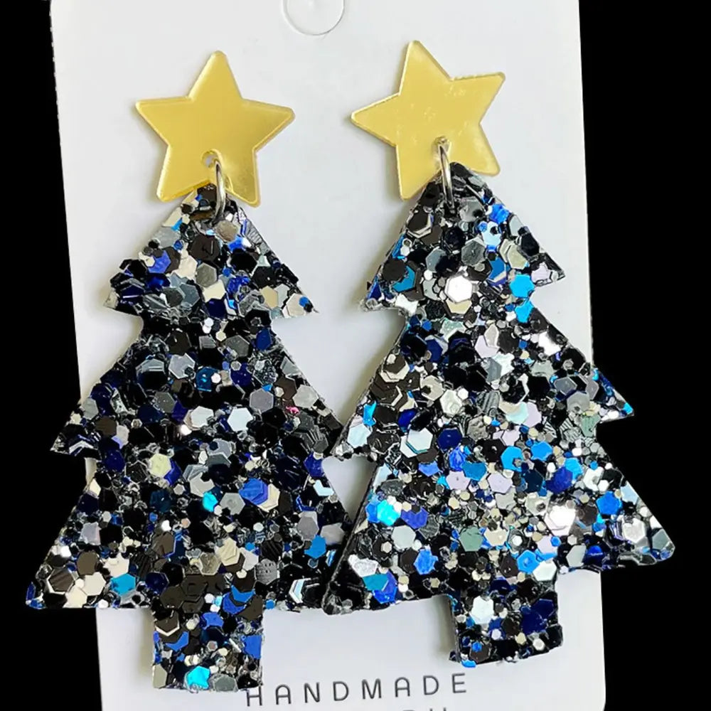 Pair of blue and black glitter acrylic Christmas tree dangle earrings on a white card.