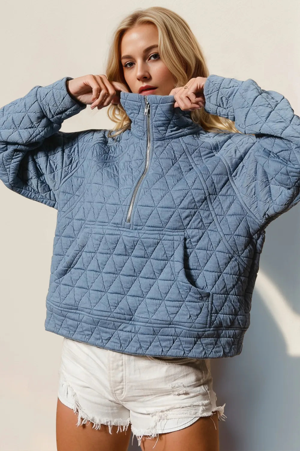 Half-zip quilted sweatshirt in gray with a sheer pocket and long sleeves.