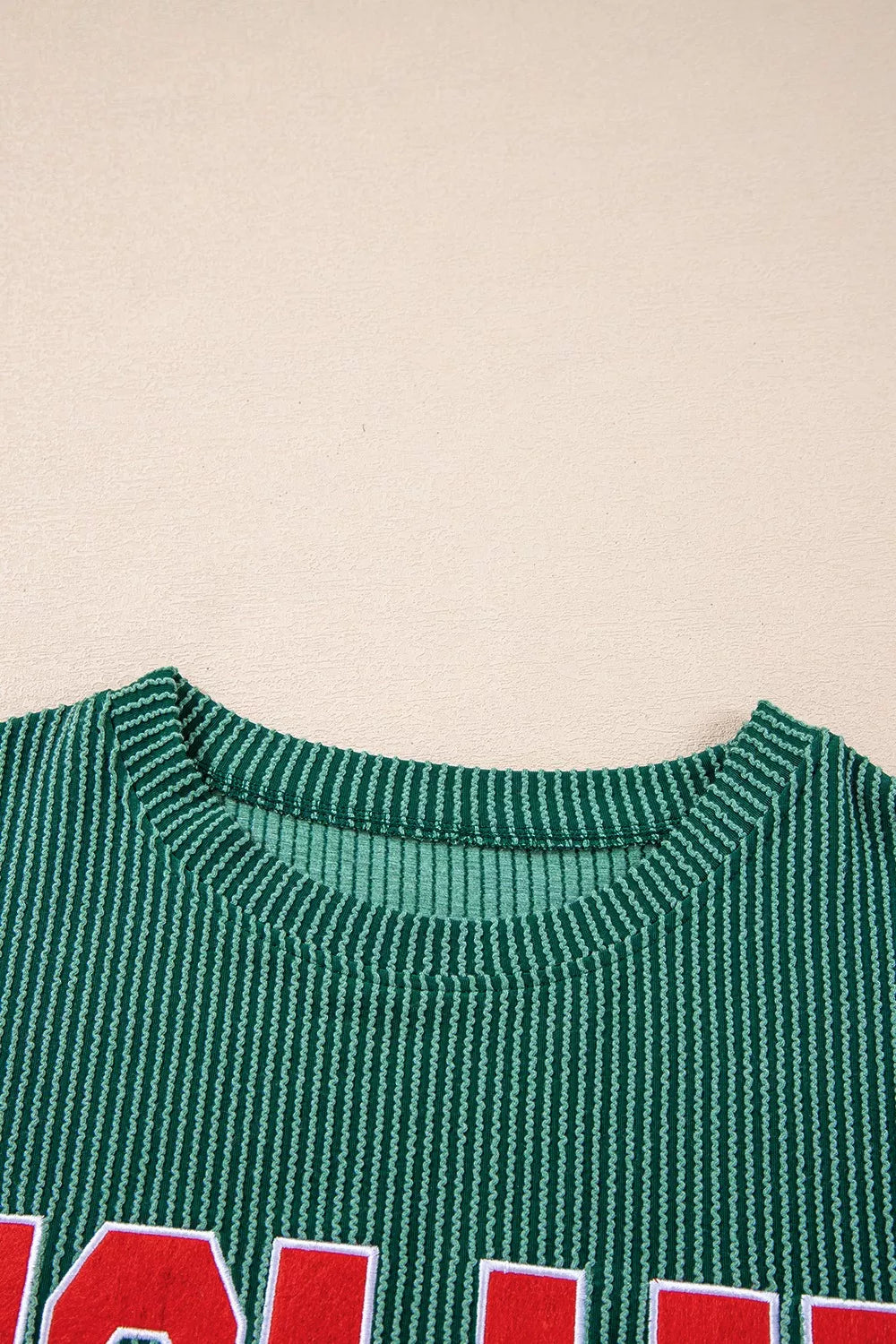 Green polyester top with red "JOLLY" text and drawstring pants set for Christmas.
