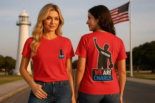 Two women model front and back views of a red Comfort Colors heavyweight T-shirt with "FREEDOM" and "WE ARE CHARLIE" prints.